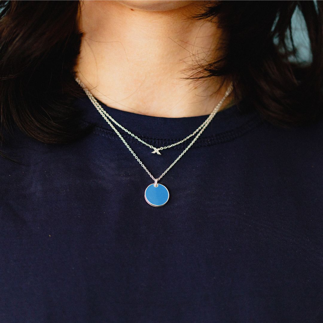 fidget locket_with hidden kiss_ light blue silver_on neck