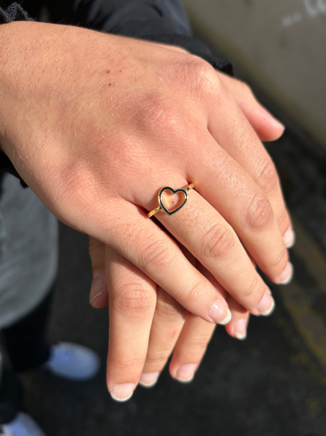 open-heart-ring-black-gold-on-hand-view
