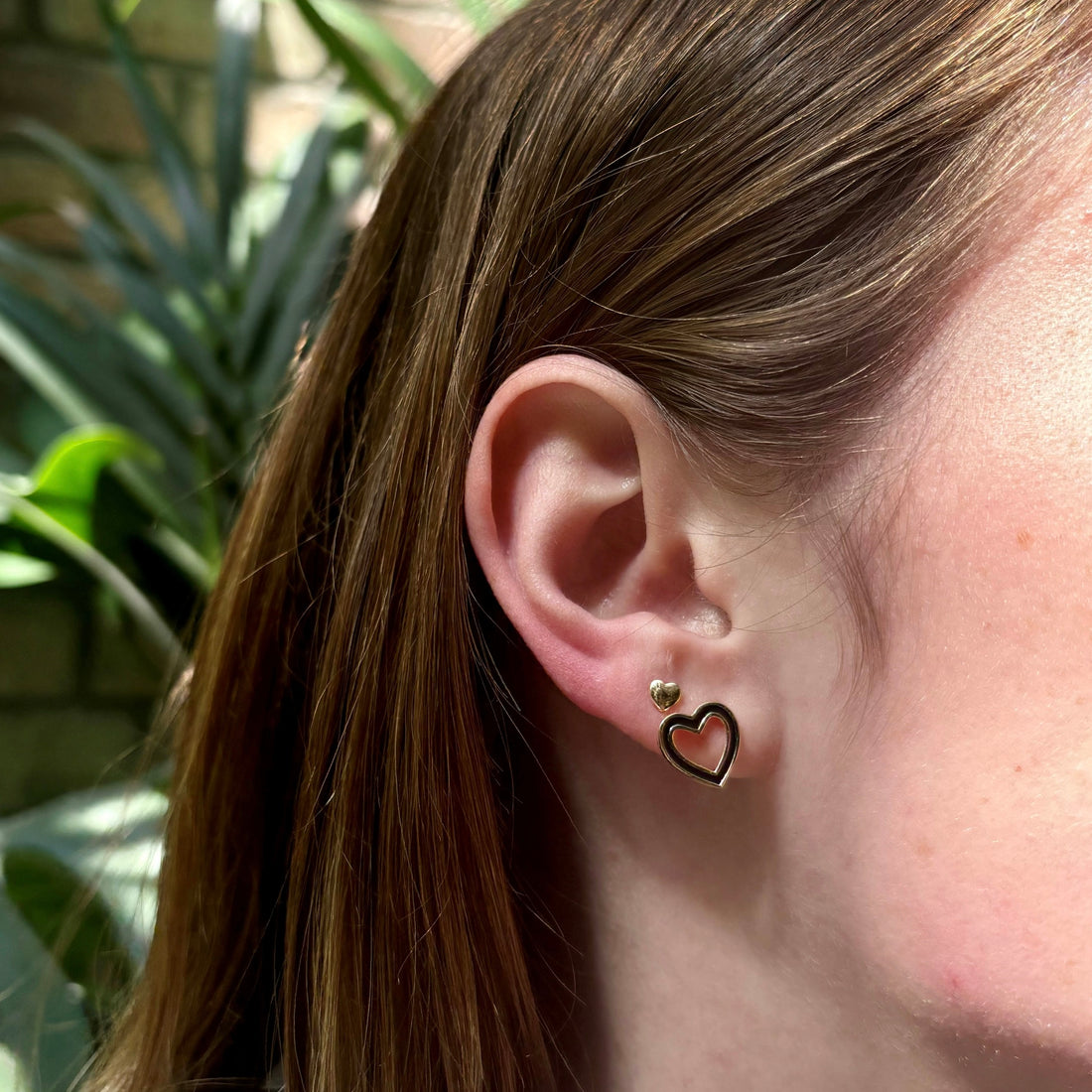 open-heart-studs-stacking-black-gold-on-ear-view
