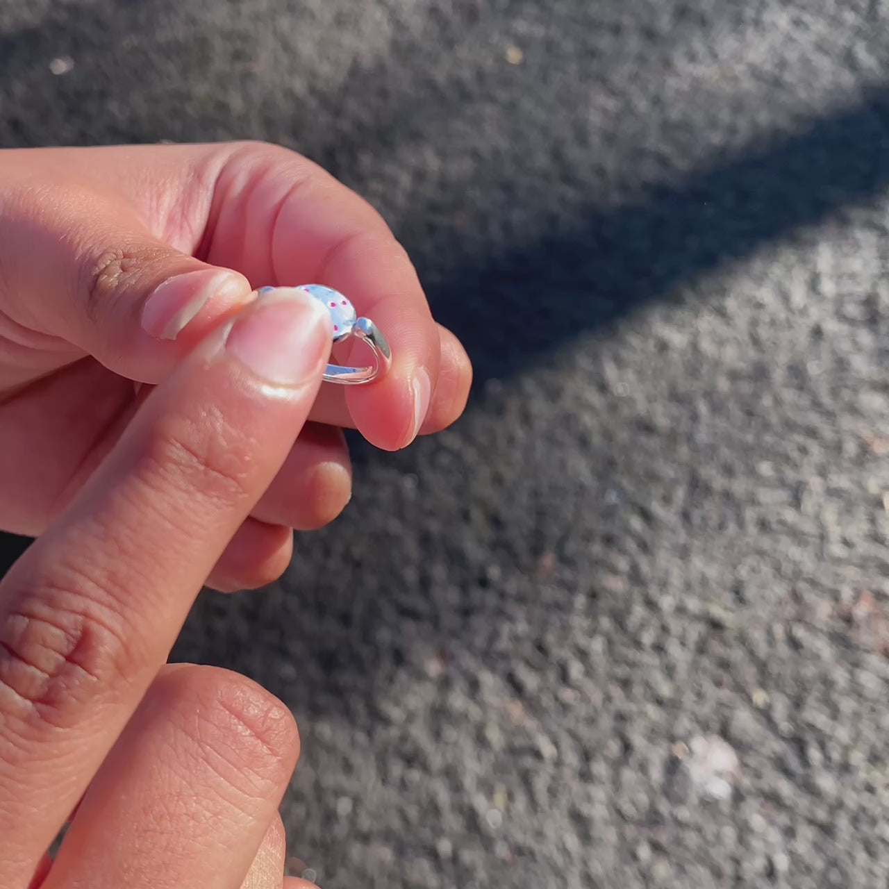 spinning-ring-pink-silver-on-hand-gif