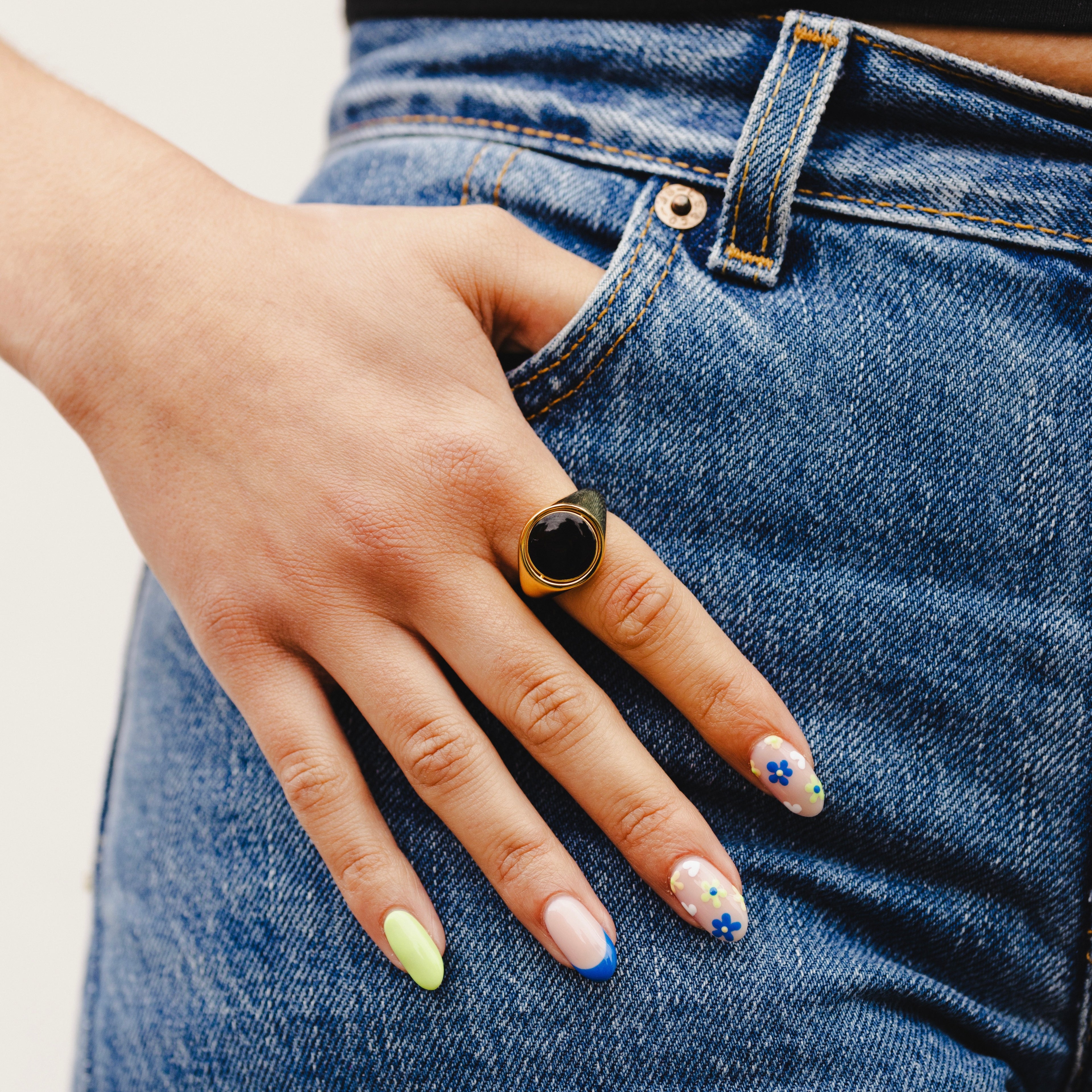 signet-ring-black-gold-in-pockets-on-hand-view